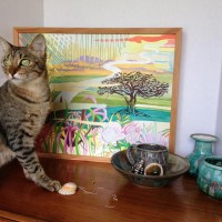 A rescue kitty among her locally made wares from High Fire Hawaii